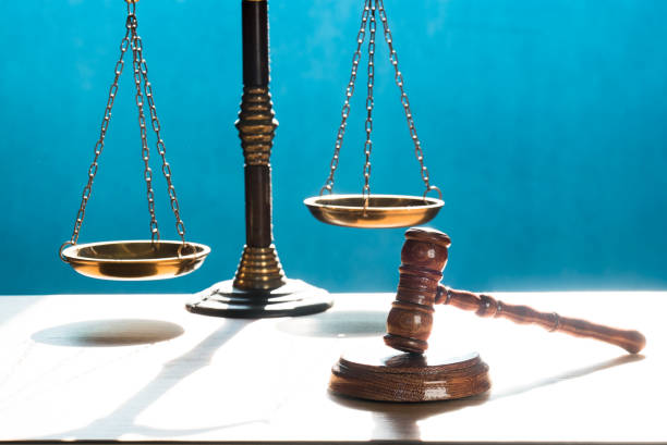 istock Concept of justice. Law scales on blue background. 1220071121