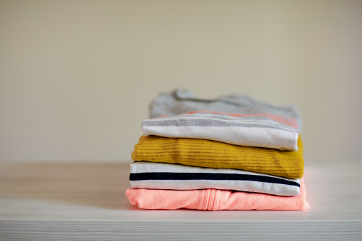 Stack colorful cotton clothes on table