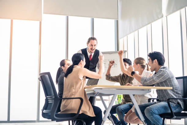 istock Group leader man and teamwork brainstorm to solve problem and presentation new idea. Manager cheer up people for new project in meeting room. Business finance and communication planning concept. 1220073283