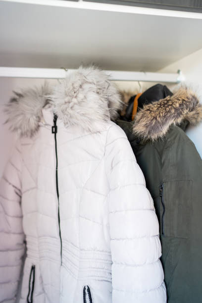 istock Man's and woman's jacket hanging in the closet 1220073528