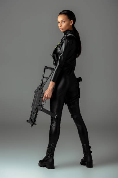 futuristic african american woman with assault rifle on grey futuristic african american woman with assault rifle on grey warrior person stock pictures, royalty-free photos & images