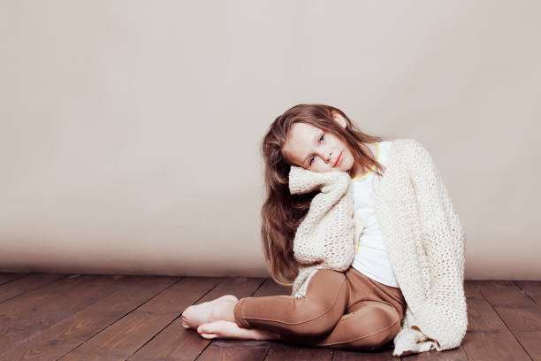 istock little girl sitting on the floor and sad 1220076849