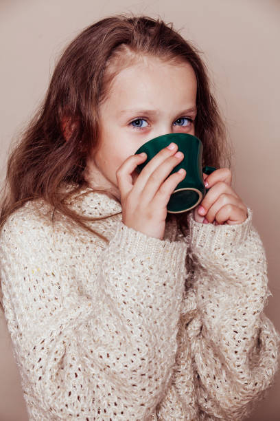 istock beautiful girl drinks from a mug tea 1220077020