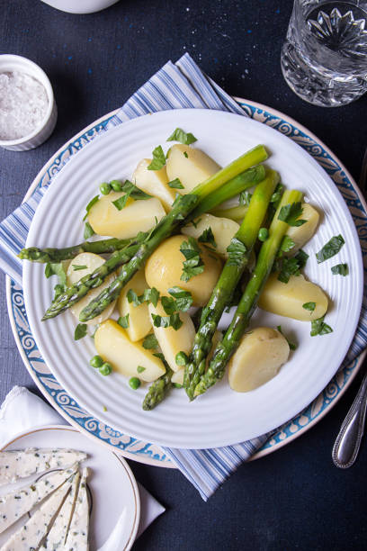 istock Boiled potato with grilled green asparagus 1220079483