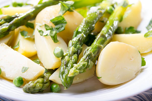istock Boiled potato with grilled green asparagus 1220079484