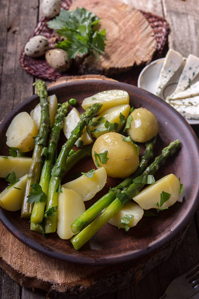 istock Boiled potato with grilled green asparagus 1220079487