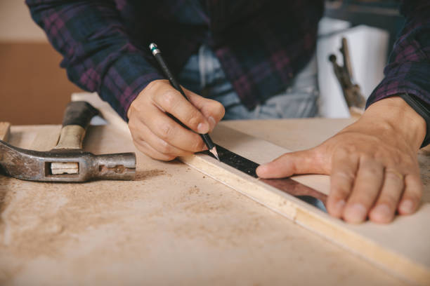 istock carpenter with a pencil and ruler mark on wooden board on table. Construction industry, housework do it yourself. 1220081554