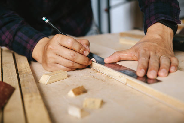 istock carpenter with a pencil and ruler mark on wooden board on table. Construction industry, housework do it yourself. 1220081564