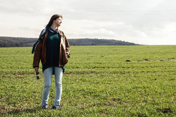 istock stylish beautiful brunette girl hipster posing  outdoors in spring field 1220083237