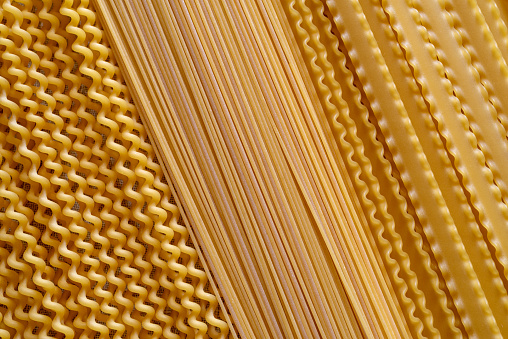 Close up pasta texture background for food preparation, representing gourmet indulgence, healthy lifestyle and city life, table top view with a copy space