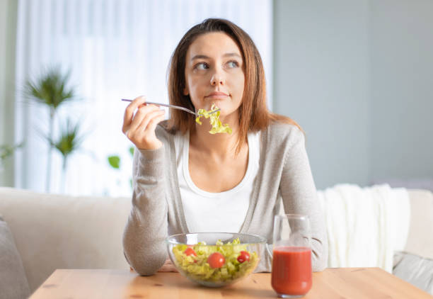 istock Woman dieting and eating a salad 1220086905