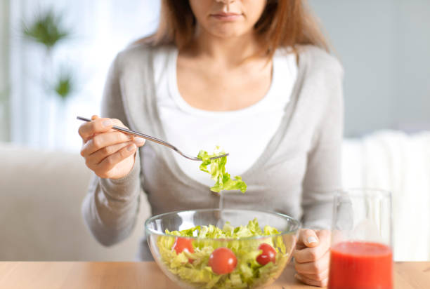 istock Woman dieting and eating a salad 1220086964