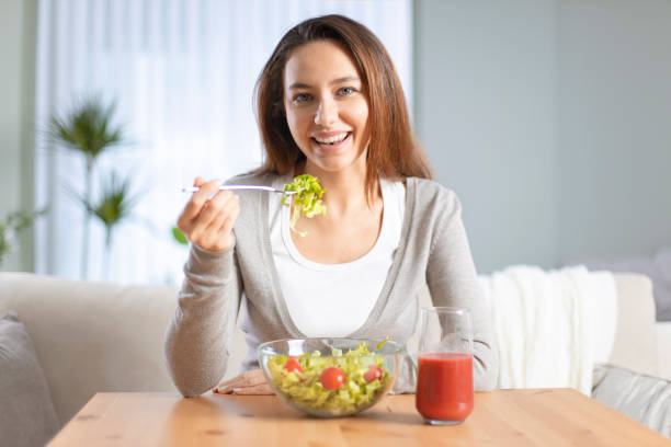 istock Woman dieting and eating a salad 1220086969