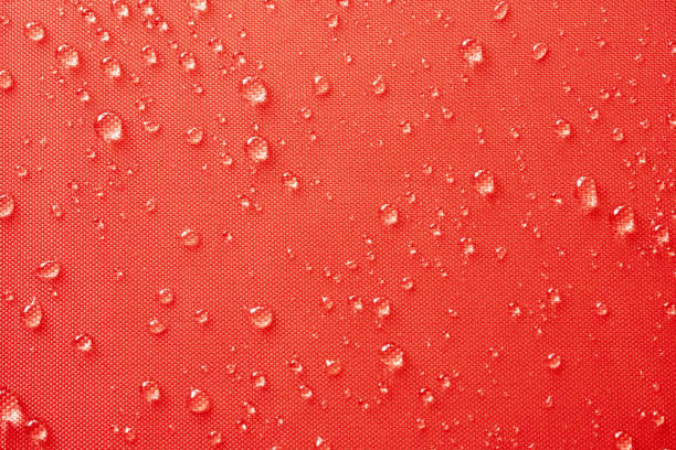 istock Water droplets on red color textile 1220087067
