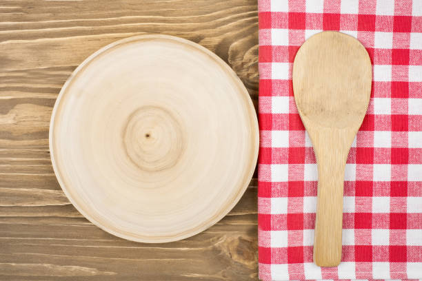 istock Red checkered tablecloth and wooden spoon for cooking and baking. Background with copy space. Horizontal. 1220087142