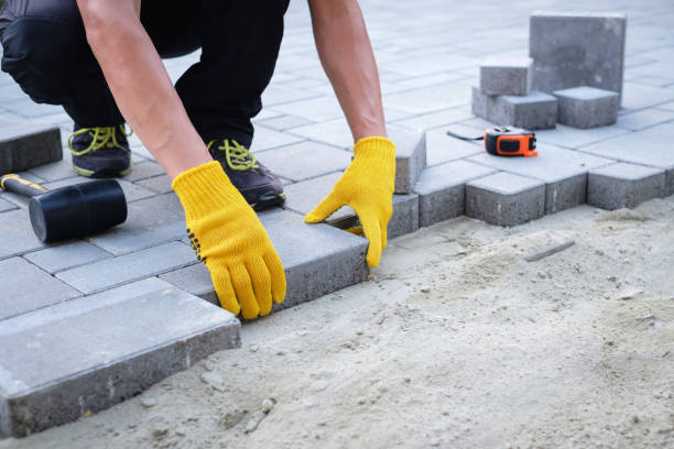 istock The master in yellow gloves lays paving stones 1220089433