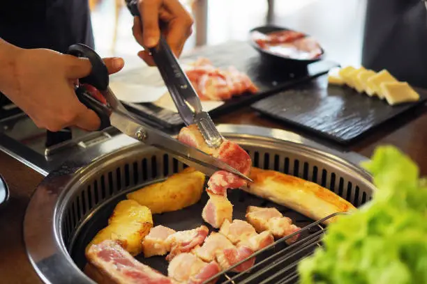 Photo of Korean grill pork belly BBQ (Samgyeopsal Gui) - trendy Korean barbecue dish, served with fresh vegetable and dipping sauce.