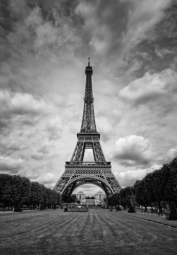 Summer sunshine falls on the Eiffel Tower in Paris. Black & white image.