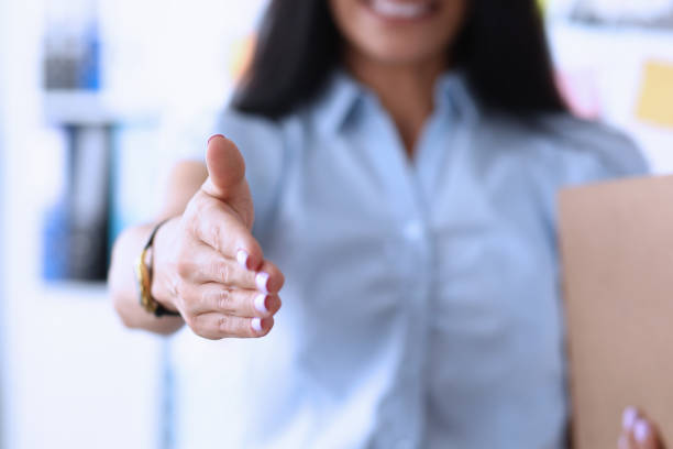 istock Smiling female manager giving hand to client 1220097186