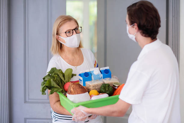 food delivery during virus outbreak. face mask. - 24241 imagens e fotografias de stock