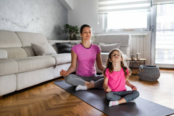 istock Mother practicing yoga with toddler daughter at home 1220099097