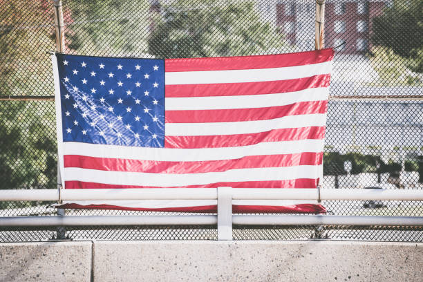 istock American flag on fence 1220100291