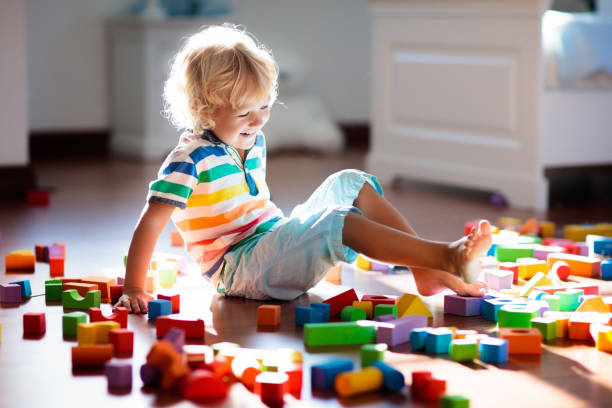 istock Child playing with colorful toy blocks. Kids play. 1220100654