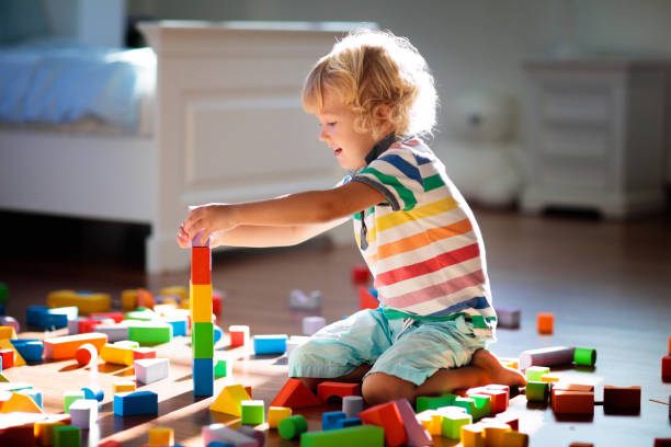 istock Child playing with colorful toy blocks. Kids play. 1220100735