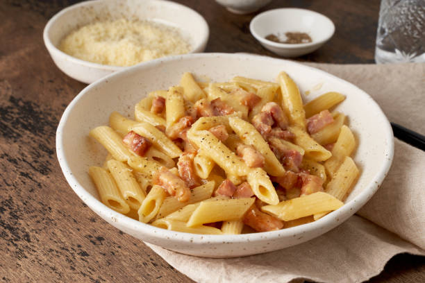 istock Carbonara pasta. Penne with pancetta, egg, parmesan cheese and cream sauce. 1220101095