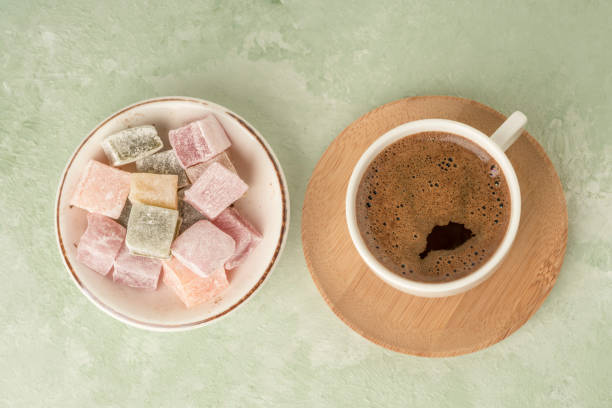 Turkish delights and coffee on green with copy space