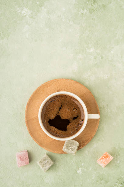 colorful Turkish delights and coffee on green with copy space