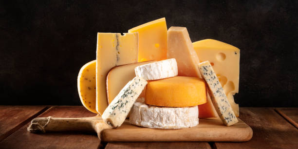 istock Cheese panorama, many different types of cheeses, a side view on a dark background 1220103715