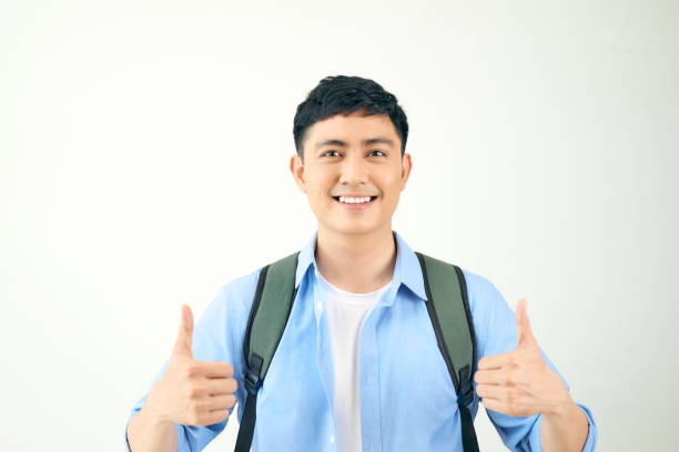 istock Young man giving two thumbs up isolated on white background 1220106338