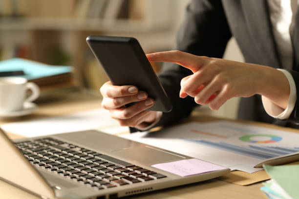 istock Entrepreneur hands using phone at night at home 1220106919