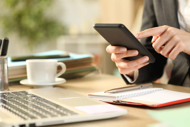 istock Entrepreneur hands with agenda using phone 1220106938