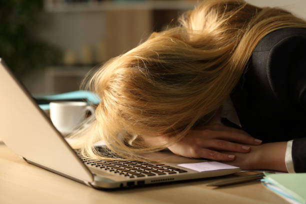istock Overworked entrepreneur sleeping over desk at night 1220108014