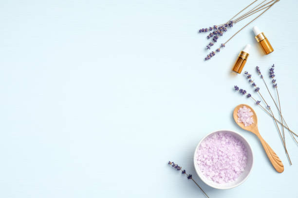 istock Lavender salt with natural spa products and herb on blue background. Flat lay, top view, copy space. Skin care, bath treatment concept 1220109592
