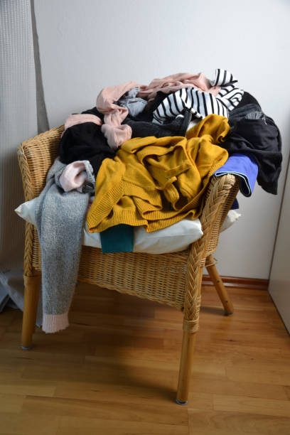 Pile of clothes on a chair stock photo