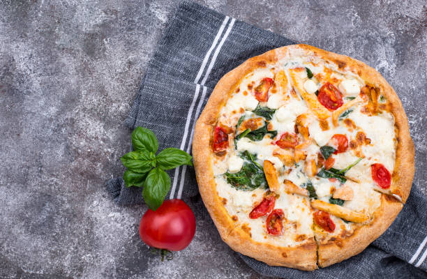 istock Italian pizza with tomato, mozzarella and chicken 1220110115