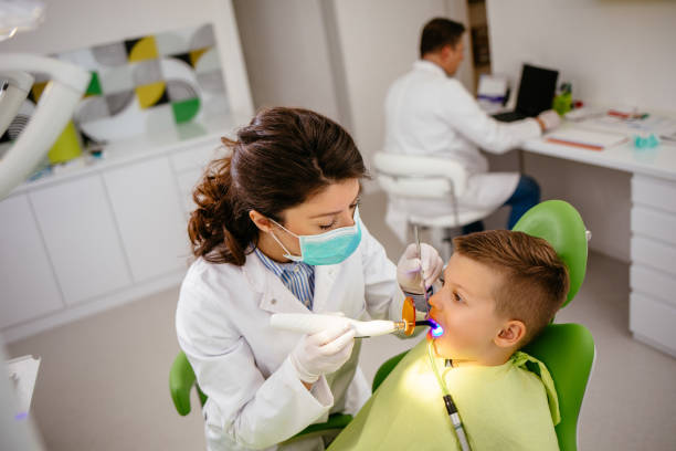 istock Boy receiving dental filling drying procedure 1220111647