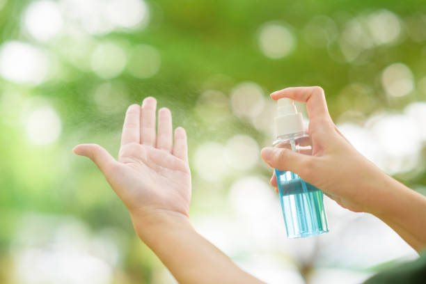 istock Close up hand with alcohol sanitizer spray outdoor 1220111917
