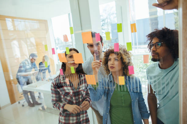 istock Business team brainstorming in front of glass wall 1220113156