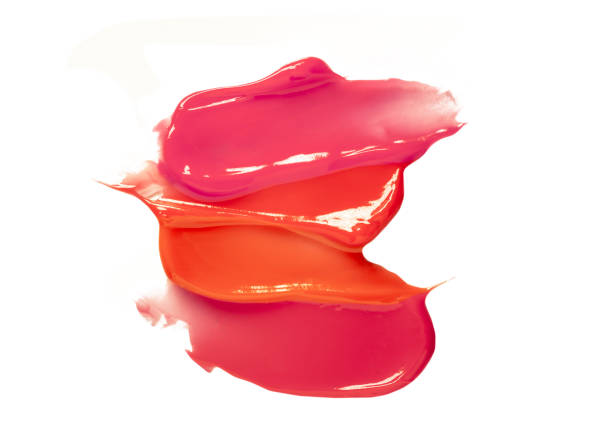 Pink purple dark red shimmering lip gloss on white background