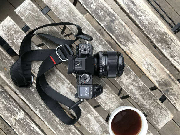 istock Travel camera and coffee cup on wooden table 1220114336