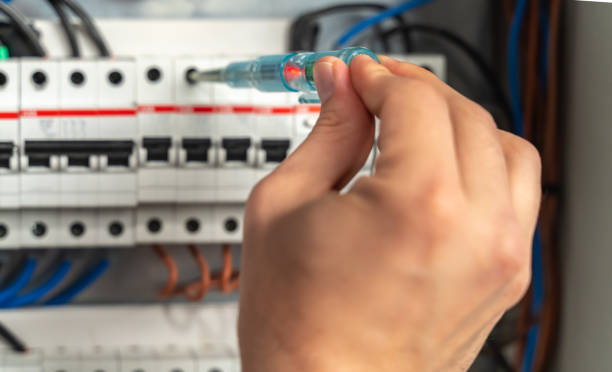 istock Electrician checking fuse box, close-up 1220114616