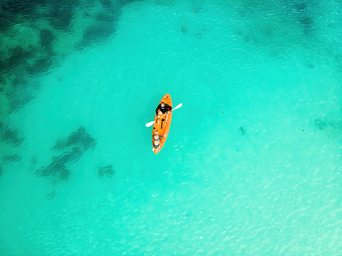 Top view from a drone of a canoe in tropical waters, in Seychelles, Mahe Island