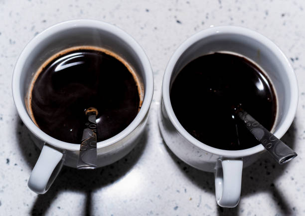 istock Two white cups of coffee top view 1220114790