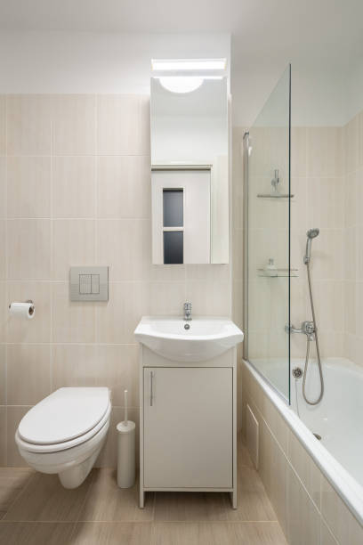 istock Simple bathroom with beige tiles 1220116411