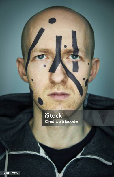 Close Up Portrait Of Man Hiding His Face From Camera Recognition With Special Camouflage Makeup Digital Privacy In Big City Concept Image Stock Photo - Download Image Now