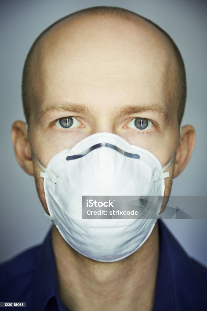 Closeup portrait of man wearing protective mask against virus and pollution Adult Stock Photo